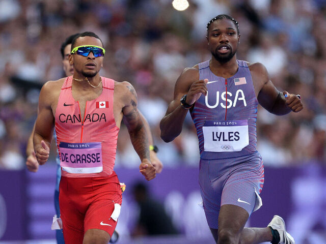 Lyles, Defending Champ De Grasse Ease Through to 200m Semis